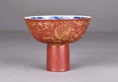 Lot 129 - A Chinese iron red and gilt blue and white stem cup, Jiajing mark but later