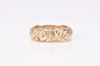 Lot 276 - A 9ct gold diamond set band