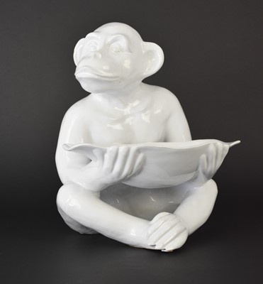 Lot 169 - A large fruit bowl in the form of a monkey holding a basket, 20th century