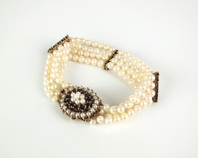 Lot 53 - A multi-strand cultured pearl bracelet with garnet and seed pearl clasp