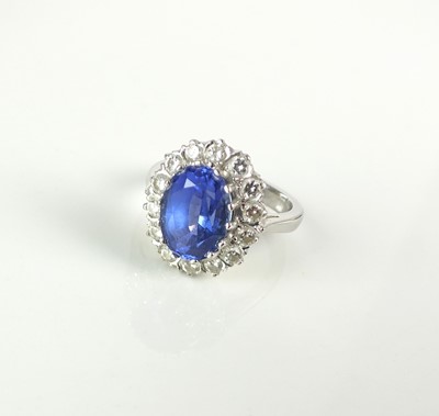 Lot 77 - An 18ct white gold tanzanite and diamond cluster ring