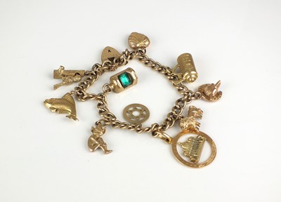 Lot 33 - A 9ct gold charm bracelet with attached 9ct gold and yellow metal charms