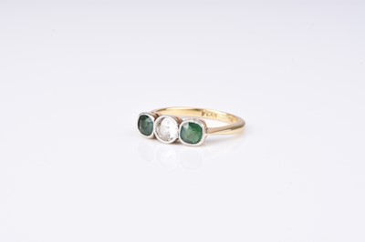 Lot 112 - A diamond and green stone ring