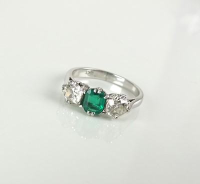 Lot 34 - A three stone emerald and diamond ring