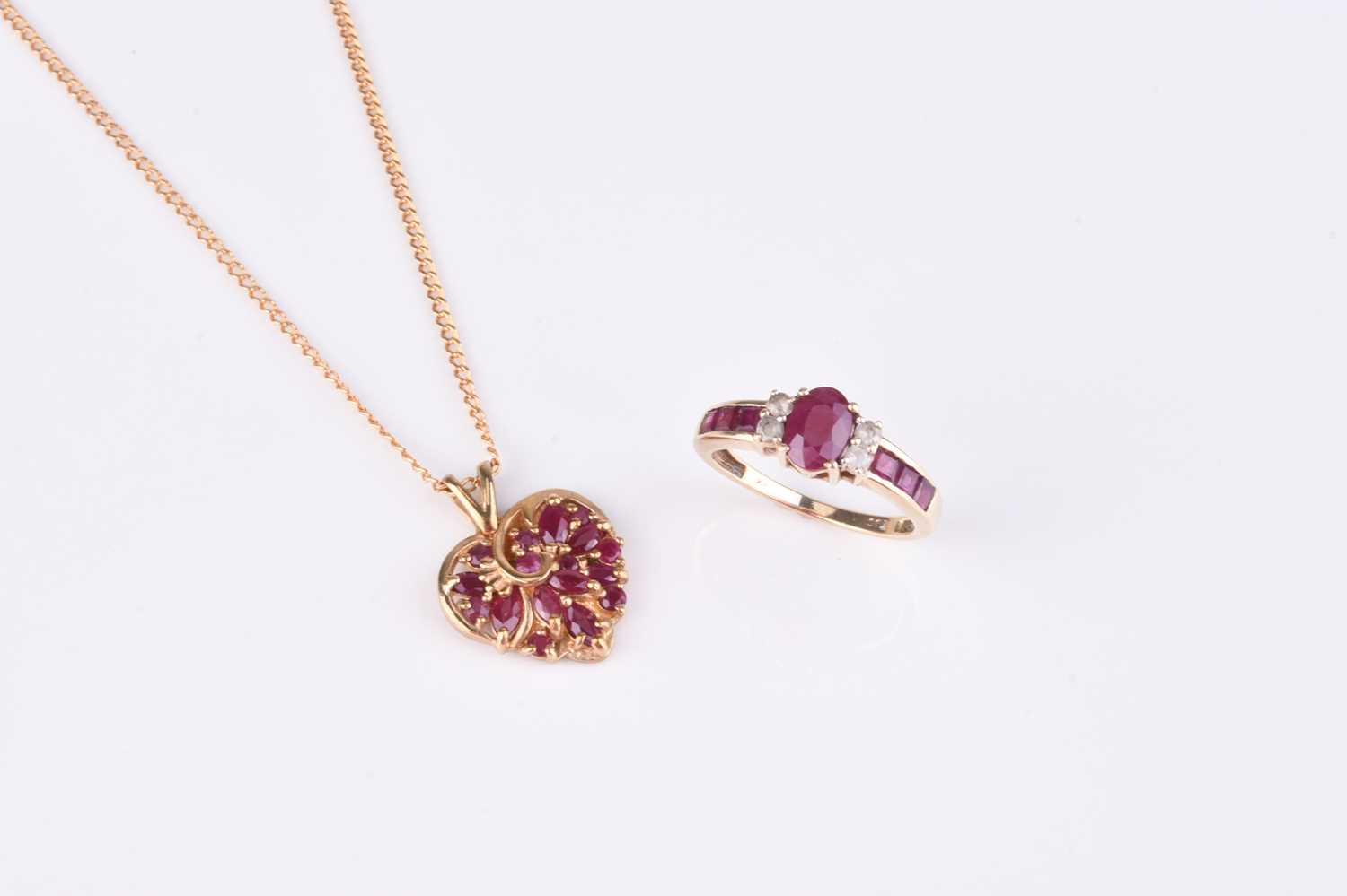 Lot 136 - A 9ct gold heart shaped ruby set pendant on chain and a ruby ring