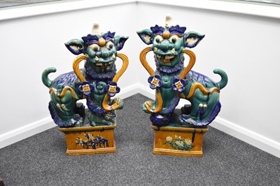 Lot 36 - A large pair of Chinese sancai glazed figures of guardian lions, Republic period