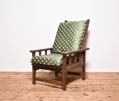 Lot 224 - An Arts & Crafts style oak Morris type reclining armchair