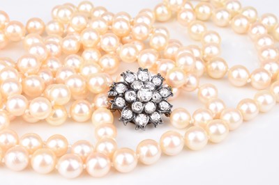 Lot 196 - A two strand cultured pearl necklace with diamond set clasp