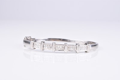 Lot 124 - A Princess cut diamond set hinged bangle