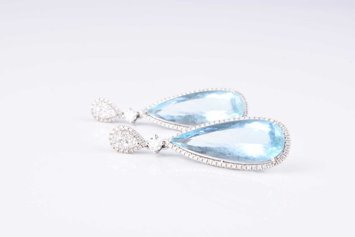 Lot 184 - A pair of 18ct white gold aquamarine and diamond ear pendants