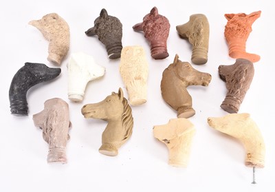 Lot 92 - A collection of cast resin animal stick heads