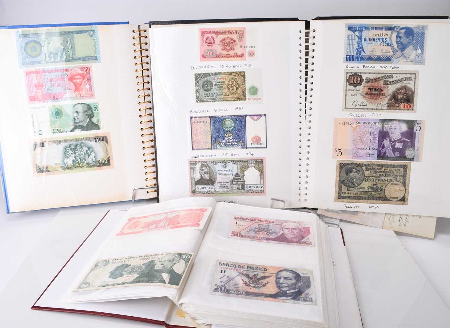 Lot 305 - Three albums of UK and foreign banknotes together with seven framed banknotes