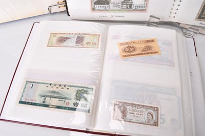 Lot 305 - Three albums of UK and foreign banknotes together with seven framed banknotes