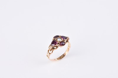 Lot 180 - A Victorian 12ct gold garnet and split pearl ring