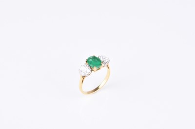 Lot 209 - An 18ct gold three stone emerald and diamond ring