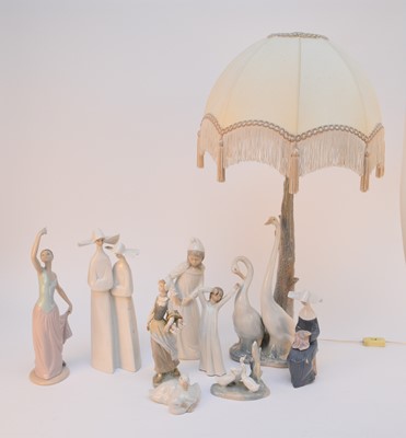 Lot 268 - A collection of Lladro and Nao figures including a table lamp