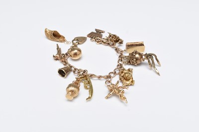 Lot 96 - A 9ct gold bracelet with attached 9ct gold and yellow metal charms