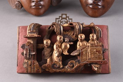 Lot 253 - A pair of Balinese carved wood wall masks and a South East Asian altar fragment