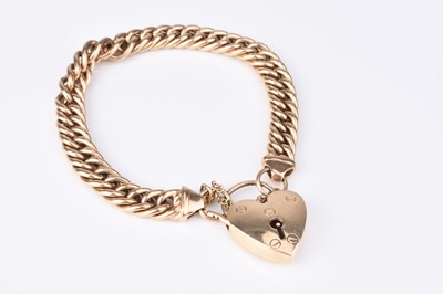 Lot 72 - A yellow metal curb link bracelet with heart shaped padlock clasp