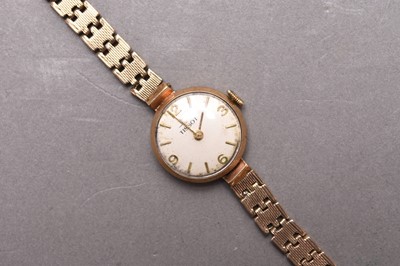 Lot 332 - Tissot: A lady's 9ct gold bracelet watch