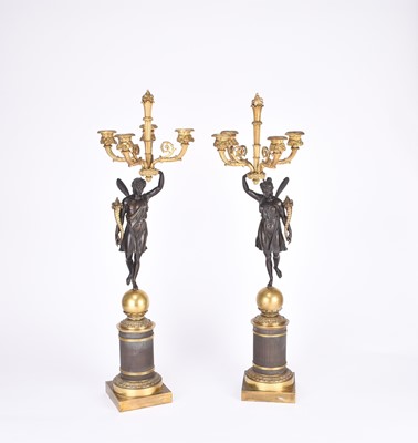 Lot 61 - A pair of French parcel gilt bronze figural candelabra