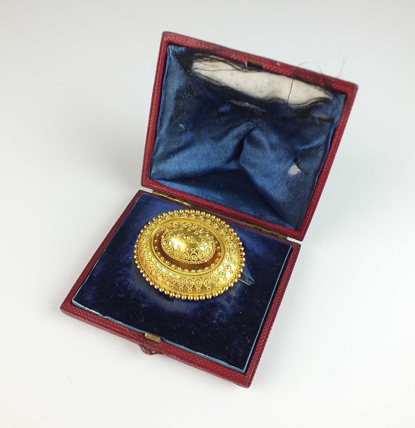 Lot 327 - A Victorian Etruscan revival oval locket brooch