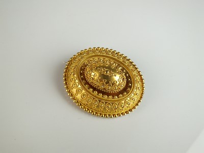 Lot 327 - A Victorian Etruscan revival oval locket brooch