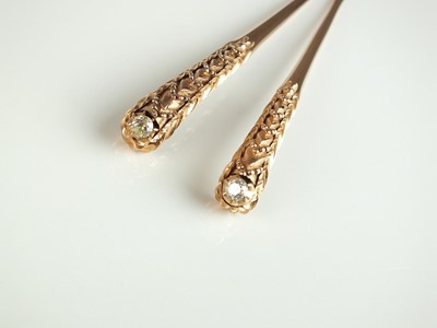 Lot 337 - Two diamond set hair pins