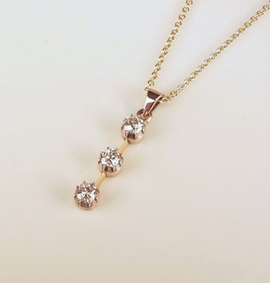 Lot 154 - A three stone diamond pendant