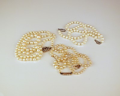 Lot 338 - Three cultured pearl necklaces and a simulated pearl necklace