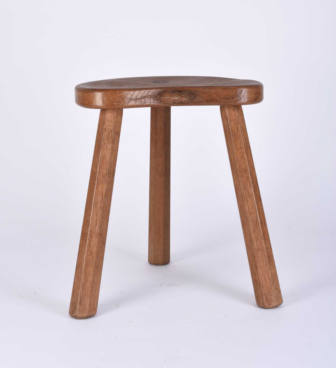 Lot 122 - Robert Mouseman Thompson, Studio of, an oak three-legged 'cow' stool