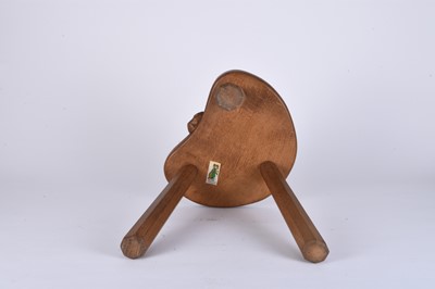 Lot 122 - Robert Mouseman Thompson, Studio of, an oak three-legged 'cow' stool