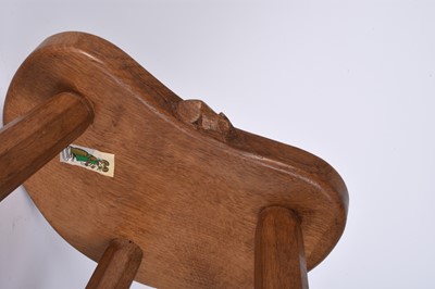 Lot 122 - Robert Mouseman Thompson, Studio of, an oak three-legged 'cow' stool