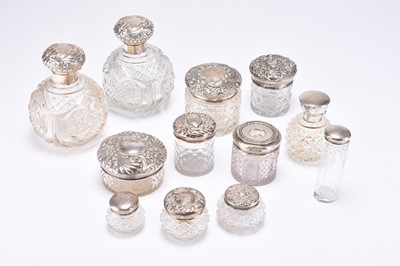 Lot 60 - A group of twelve silver topped glass dressing table jars/bottles