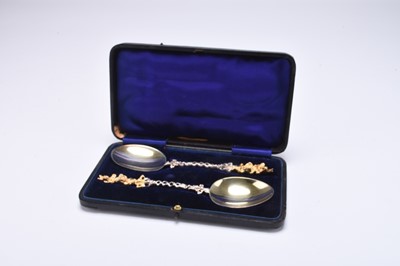 Lot 107 - A cased pair of silver and gilt spoons