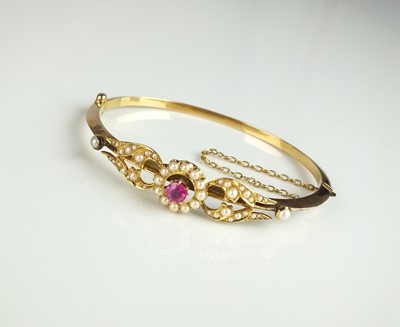 Lot 195 - A late 19th / early 20th century pink sapphire and seed pearl bangle