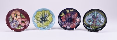 Lot 74 - A group of four Moorcroft pin dishes including Cleopatra and a bright green Hibiscus