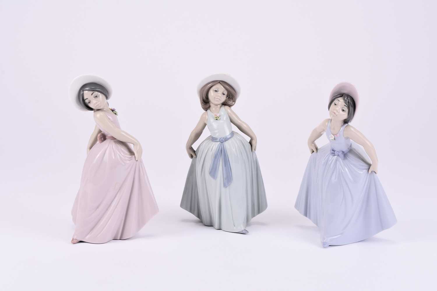 Lot 115 - Three Lladro models of young girls in dresses