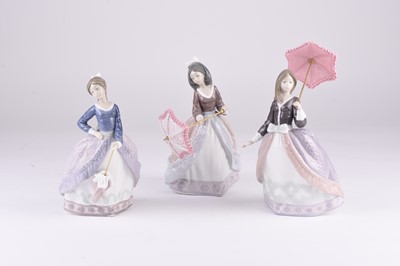 Lot 117 - Three Lladro porcelain models of women with parasols