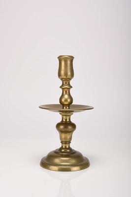 Lot 56 - A brass candle holder, 17th century