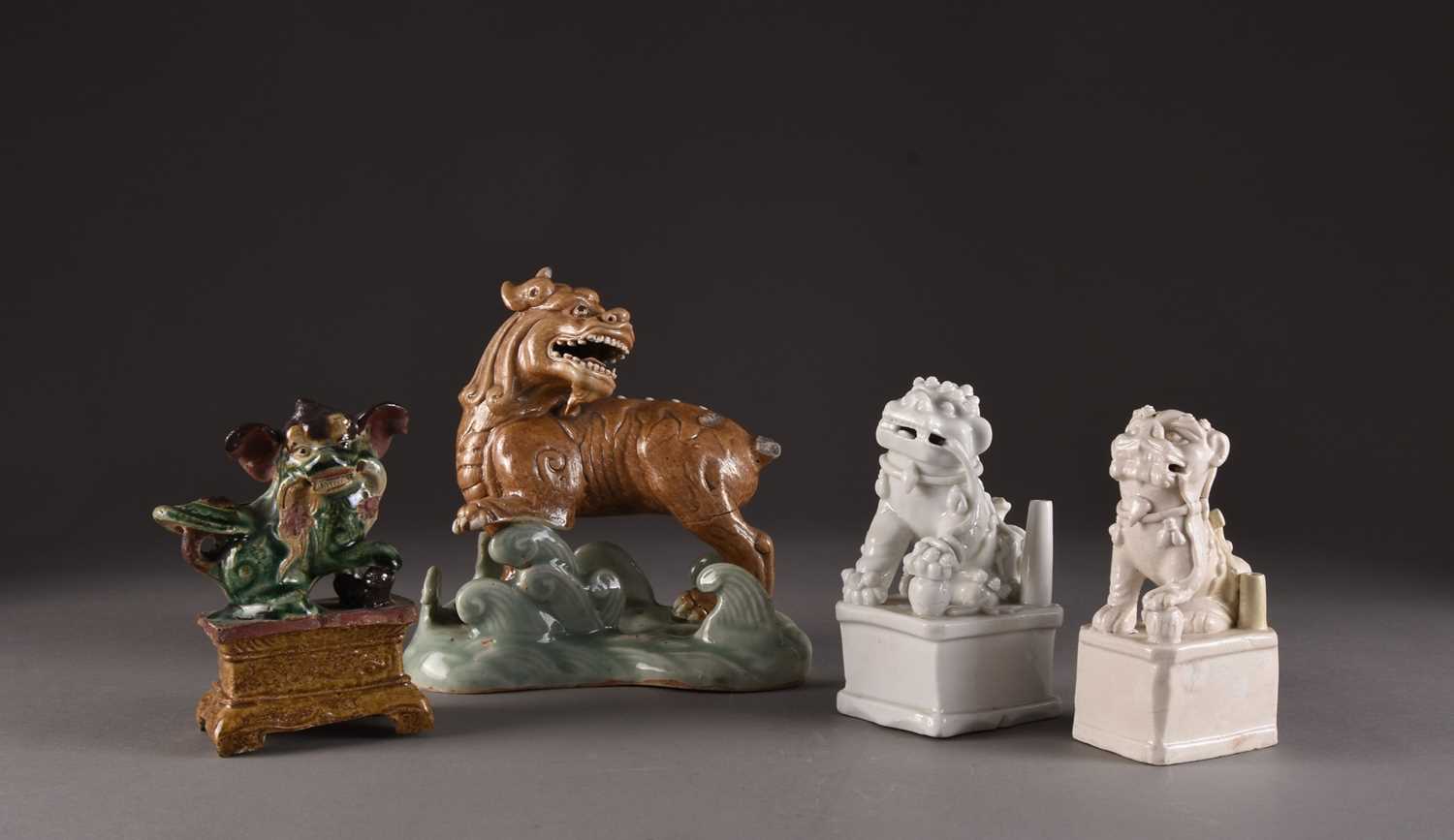 Lot 146 - A group of four Chinese figures of lion dogs