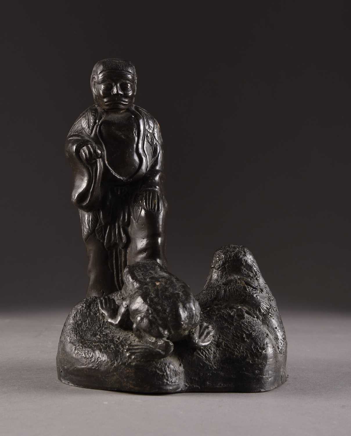 Lot 203 - A Japanese bronze figure of an oni with a toad, Meiji era