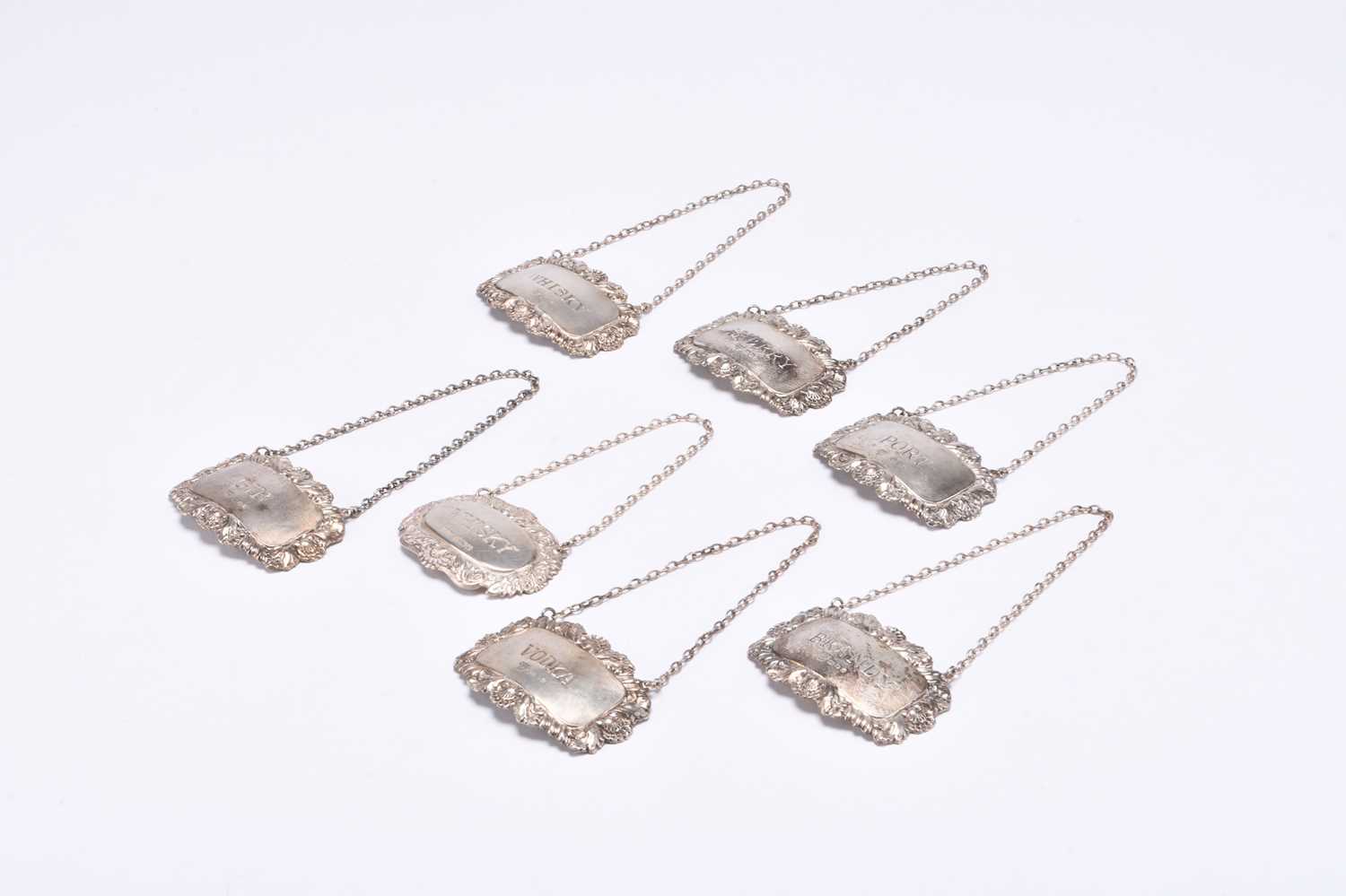 Lot 84 - Seven silver decanter labels