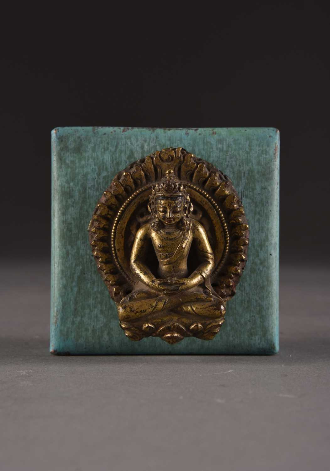 Lot 154 - A Nepalese gilt copper repoussé crowned Buddha, 17th Century