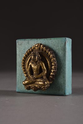 Lot 154 - A Nepalese gilt copper repoussé crowned Buddha, 17th Century