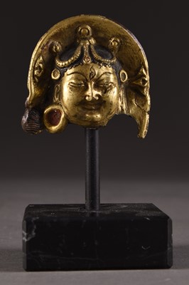 Lot 155 - A Tibetan gilt copper fragment head of a Dakini, 16th century