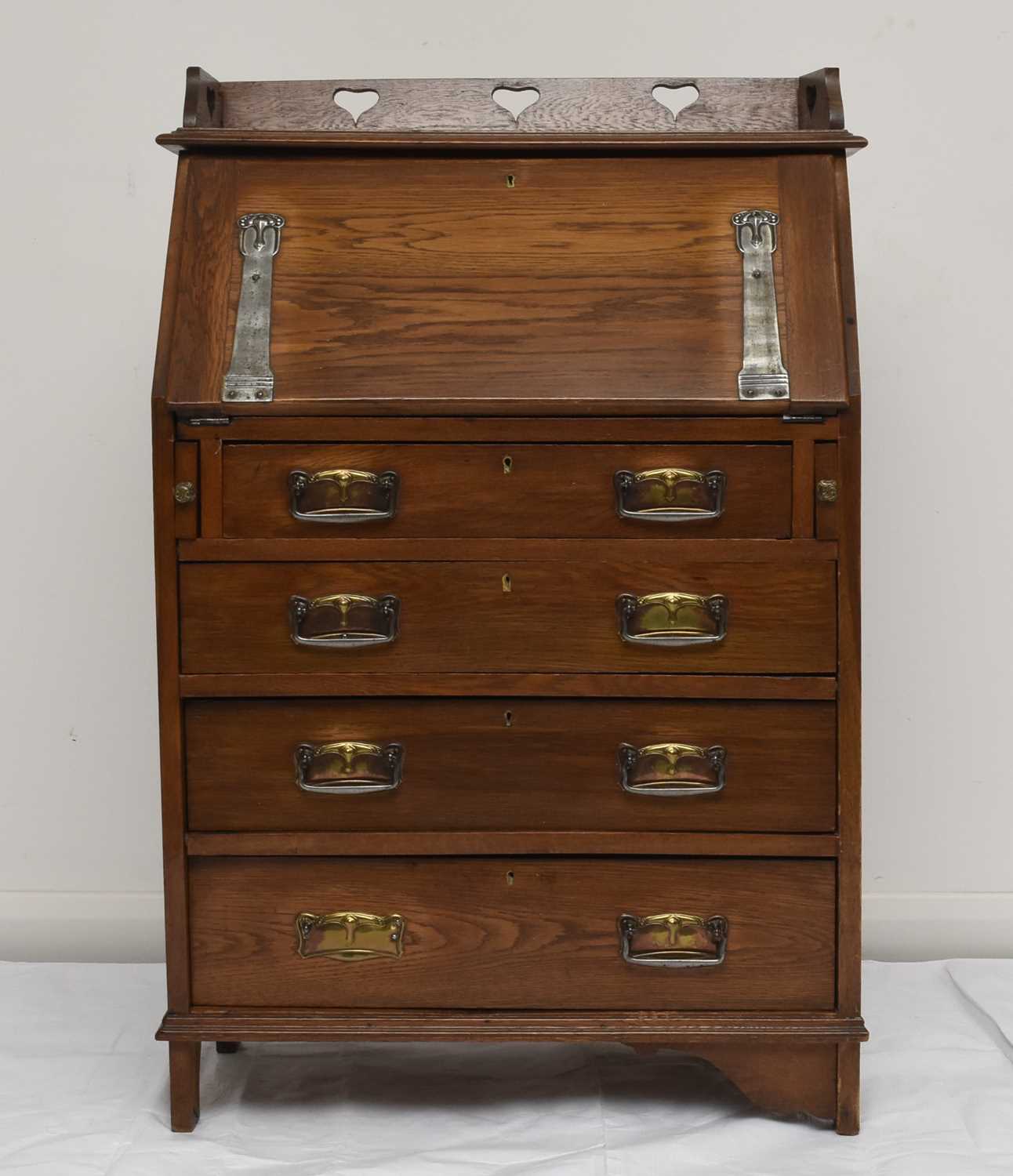 Lot 117 - An Art Nouveau style oak bureau desk