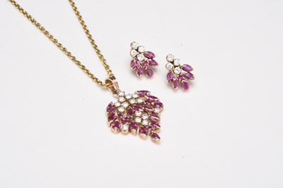 Lot 173 - A ruby and diamond pendant with matching earrings