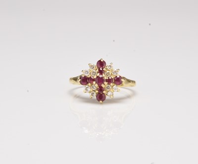 Lot 254 - An 18ct gold ruby and diamond set cluster ring