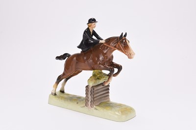 Lot 157 - Beswick model of a young woman riding sidesaddle on a jumping horse